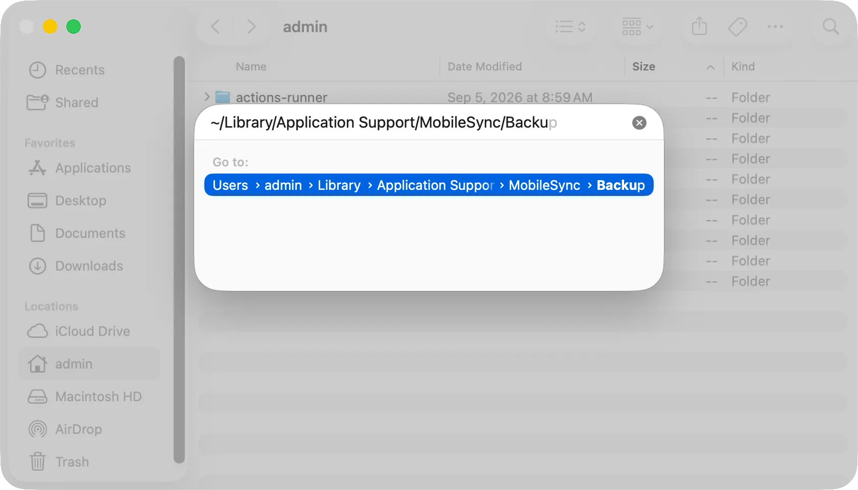 The Go to Folder panel with the iPhone backup folder path typed